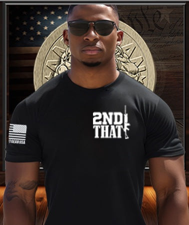 American Patriot Man wearing a Patriot Gear USA black t-shirt with '2nd That' text, sunglasses, and an American flag sleeve patch in front of a Patriot Gear Apparel COmpany logo on USA flag Background.