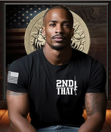 Black American Patriot wearing a black Patriot Gear USA t-shirt with '2ND THAT' text in front of American Outfitters Apparel Company Logo on  a decorative American Flag  background wall.