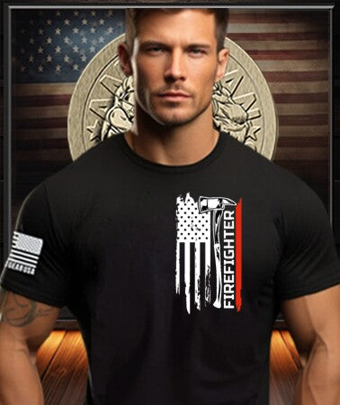 Patriot Gear USA Apparel Company Man wearing a black t-shirt with a white graphic design with Text "FIREFIGHTER" in front of a decorative wall displaying the Patriot Gear USA Company logo. 