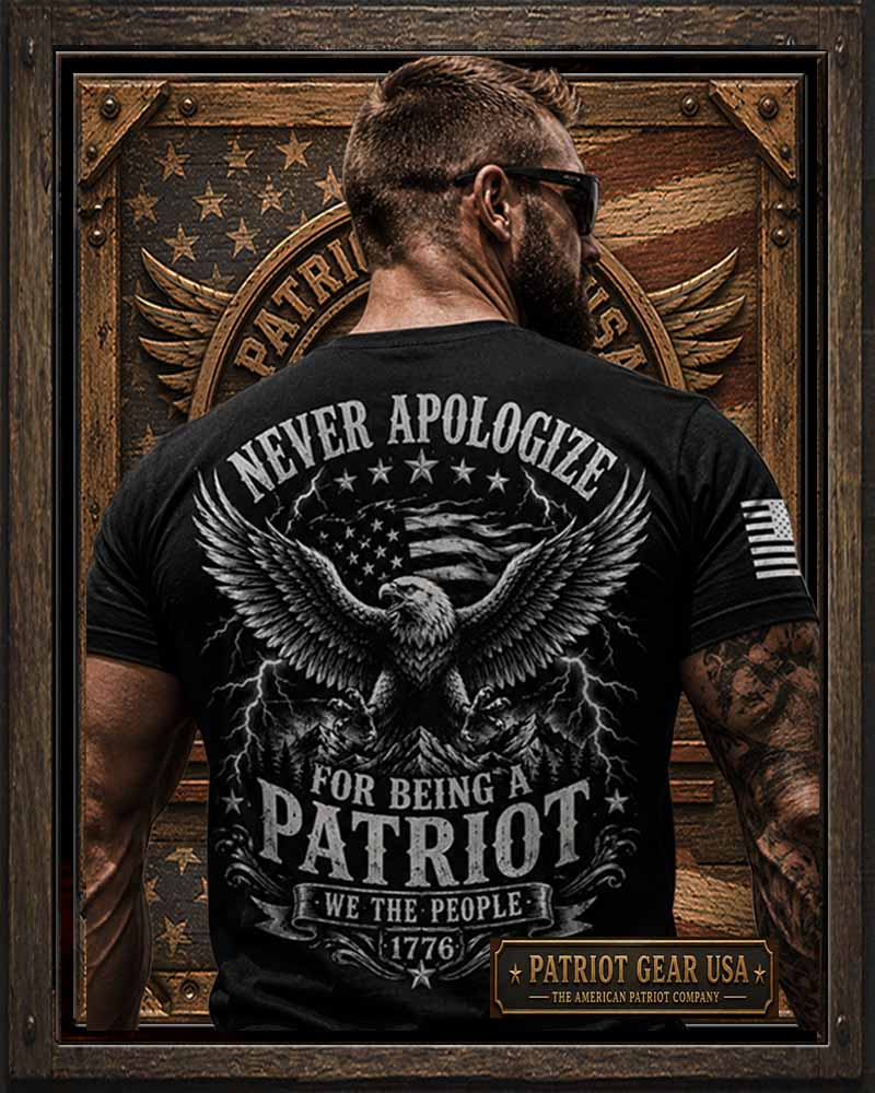 A man viewed from behind wearing a 'Patriot Gear USA' black graphic t-shirt with a large patriotic eagle design and the text 'NEVER APOLOGIZE FOR BEING A PATRIOT WE THE PEOPLE 1776'. The background is a rustic wooden American flag emblem, and the entire image is framed in a dark wood border.
